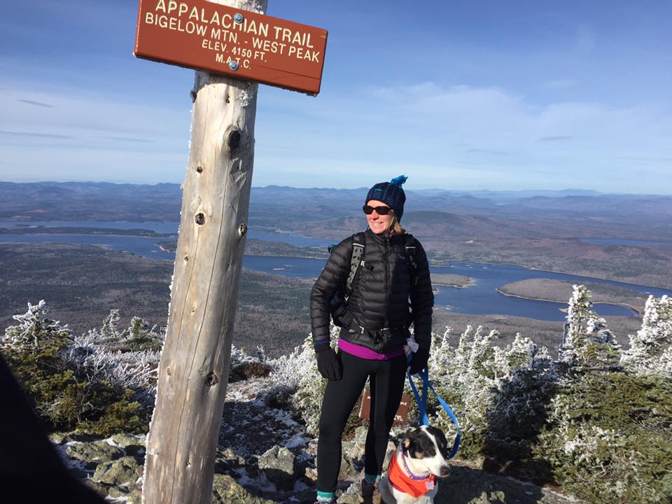 Susan standing on the peak of Bigelow Mountain.